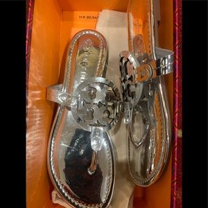 A sophisticated sandal with a foam-cushioned footbed and bold logo cutout comes.